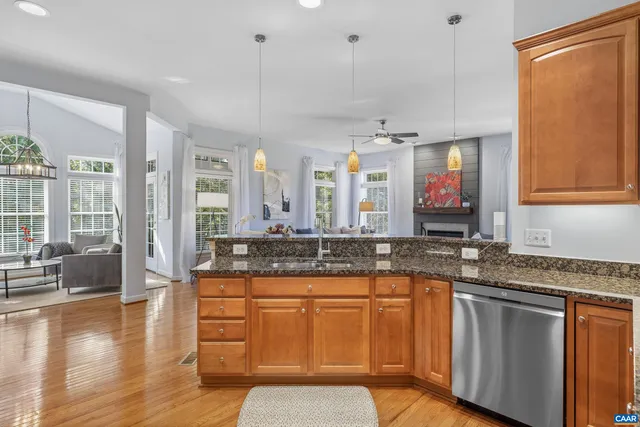 a bedroom with a bed a chair and next to a window