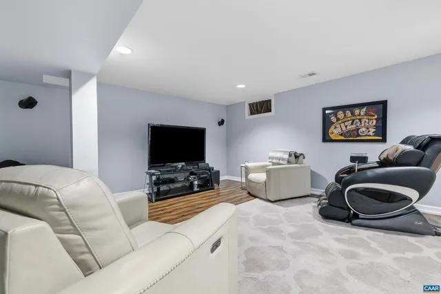 a living room with large windows and wooden floor