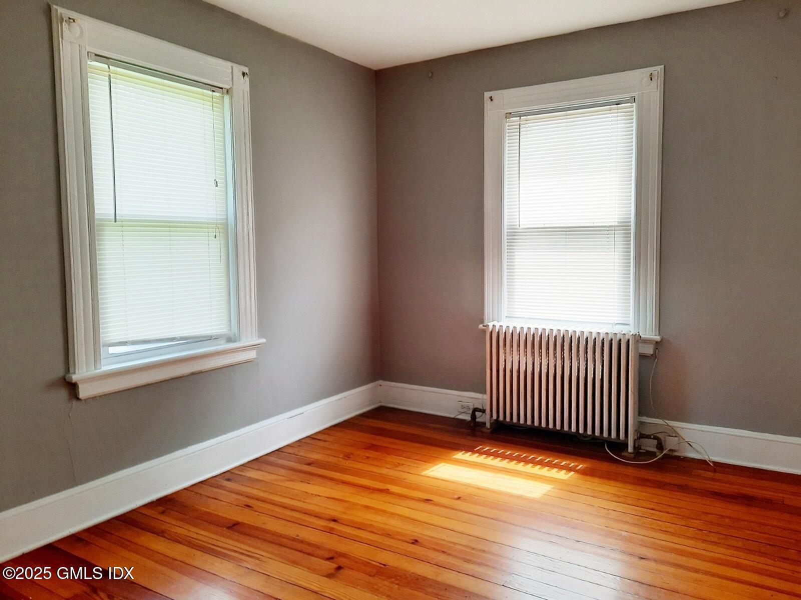 55 Valley Road Cos Cob, CT 06807 - Photo 11 of 21 an empty room with wooden floor and windows