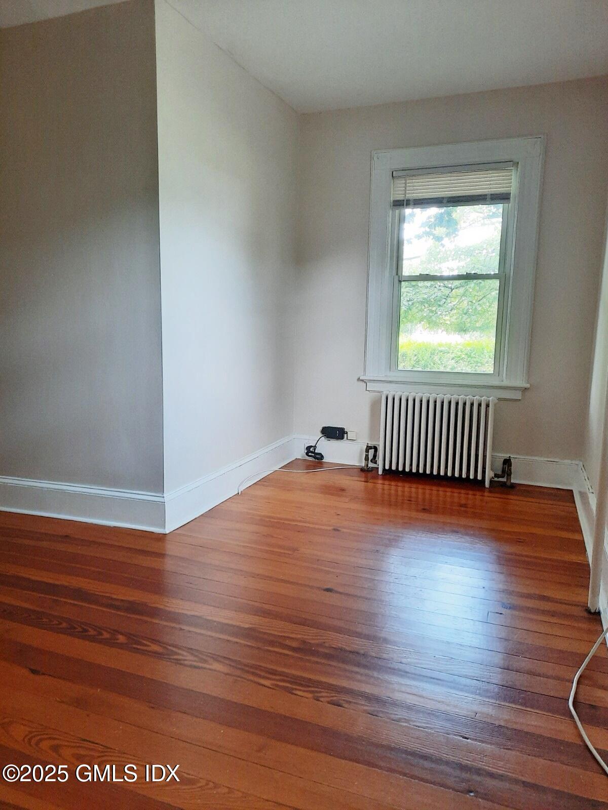 55 Valley Road Cos Cob, CT 06807 - Photo 12 of 21 a view of empty room with wooden floor and fan