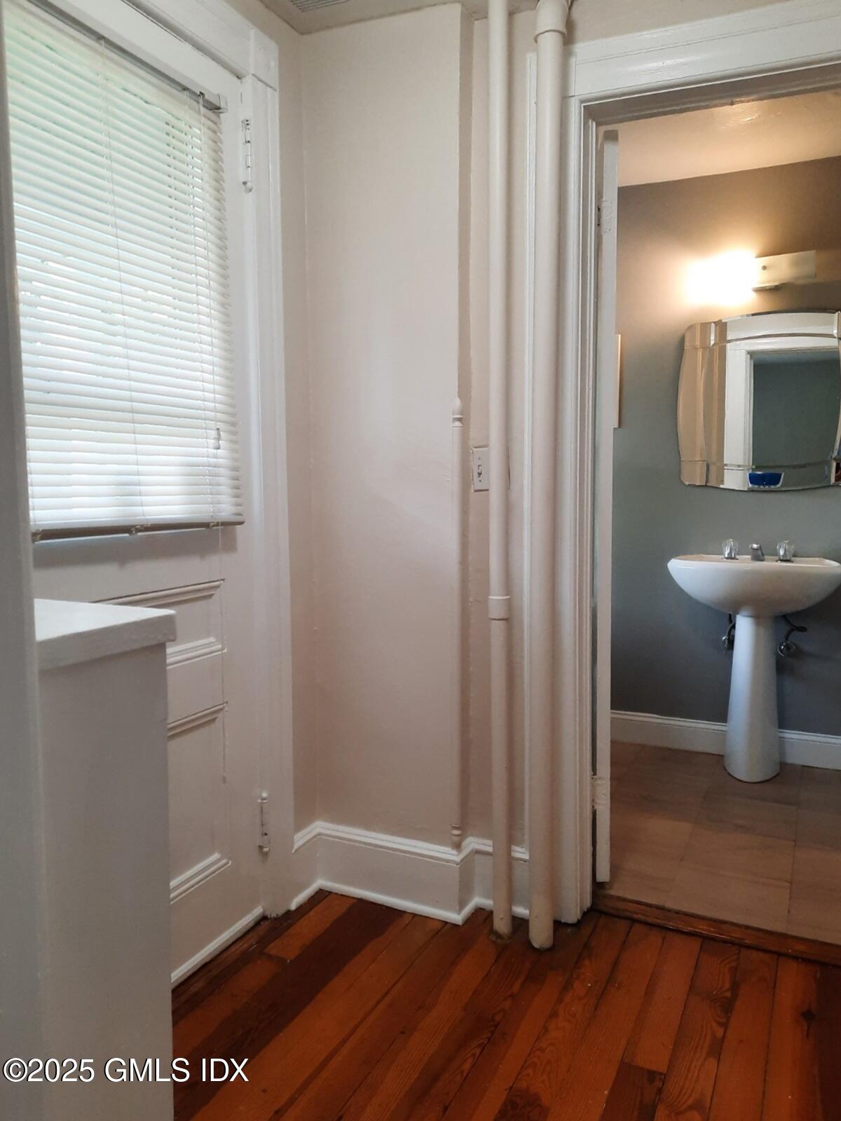 55 Valley Road Cos Cob, CT 06807 - Photo 14 of 21 a view of a hallway with wooden floor and a sink