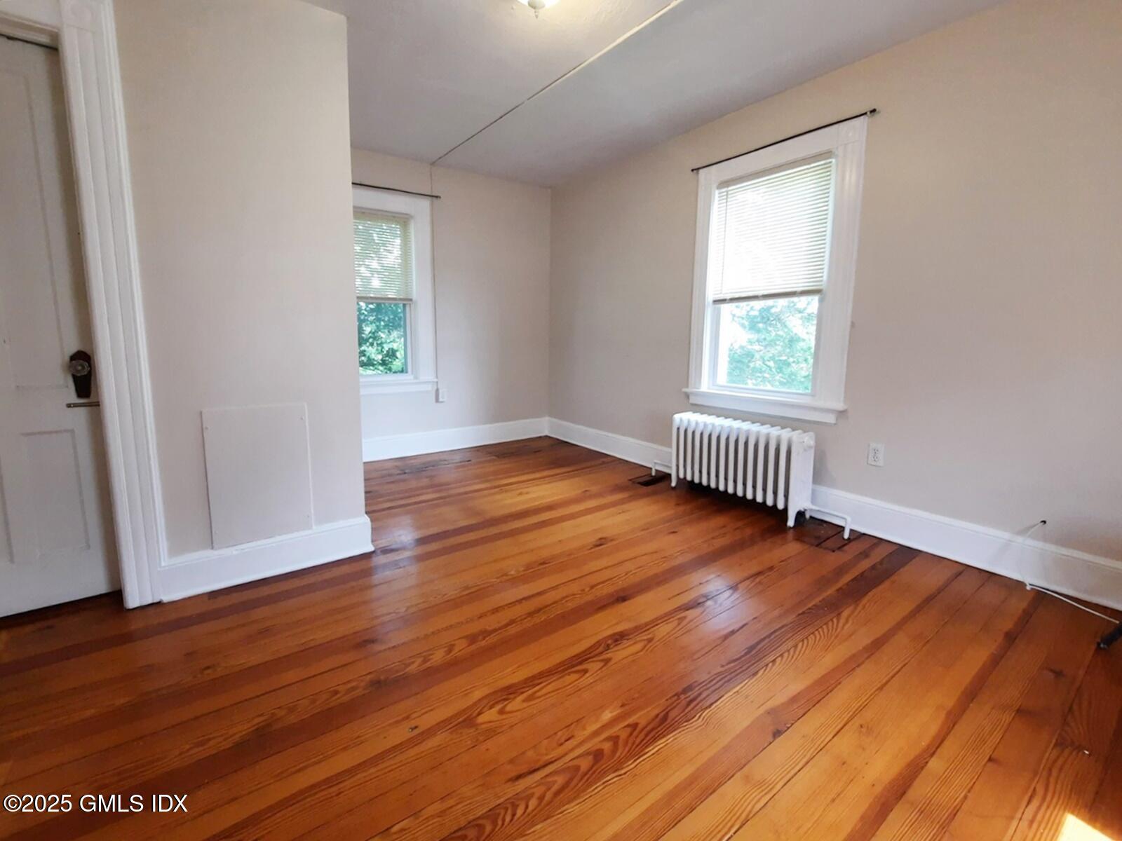 55 Valley Road Cos Cob, CT 06807 - Photo 16 of 21 an empty room with wooden floor and windows