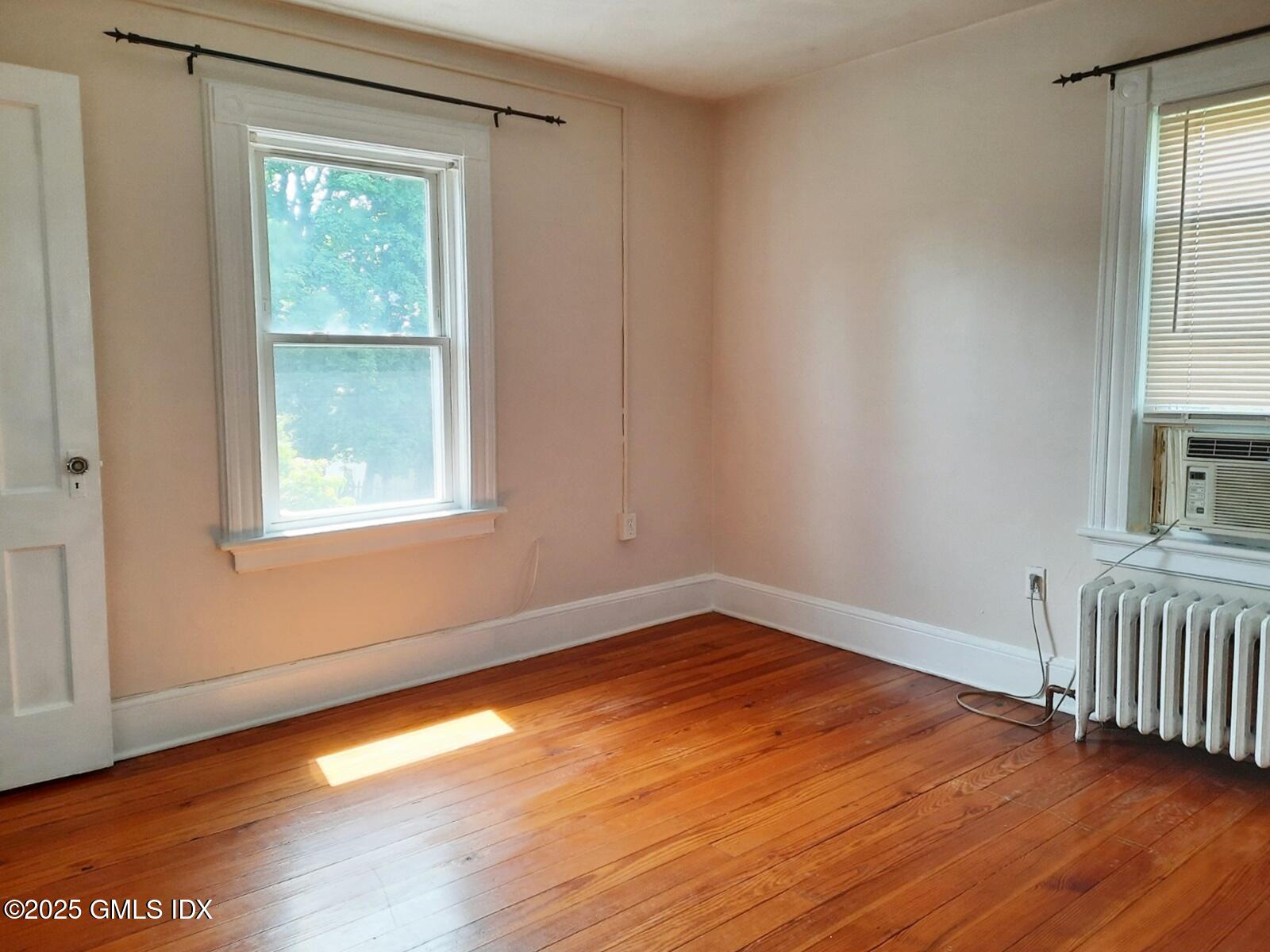 55 Valley Road Cos Cob, CT 06807 - Photo 19 of 21 a view of an empty room with wooden floor and a window