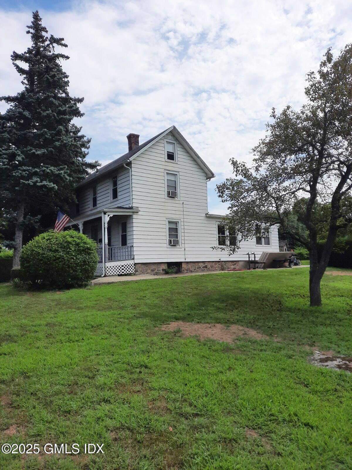 55 Valley Road Cos Cob, CT 06807 - Photo 2 of 21 a front view of house with yard and green space