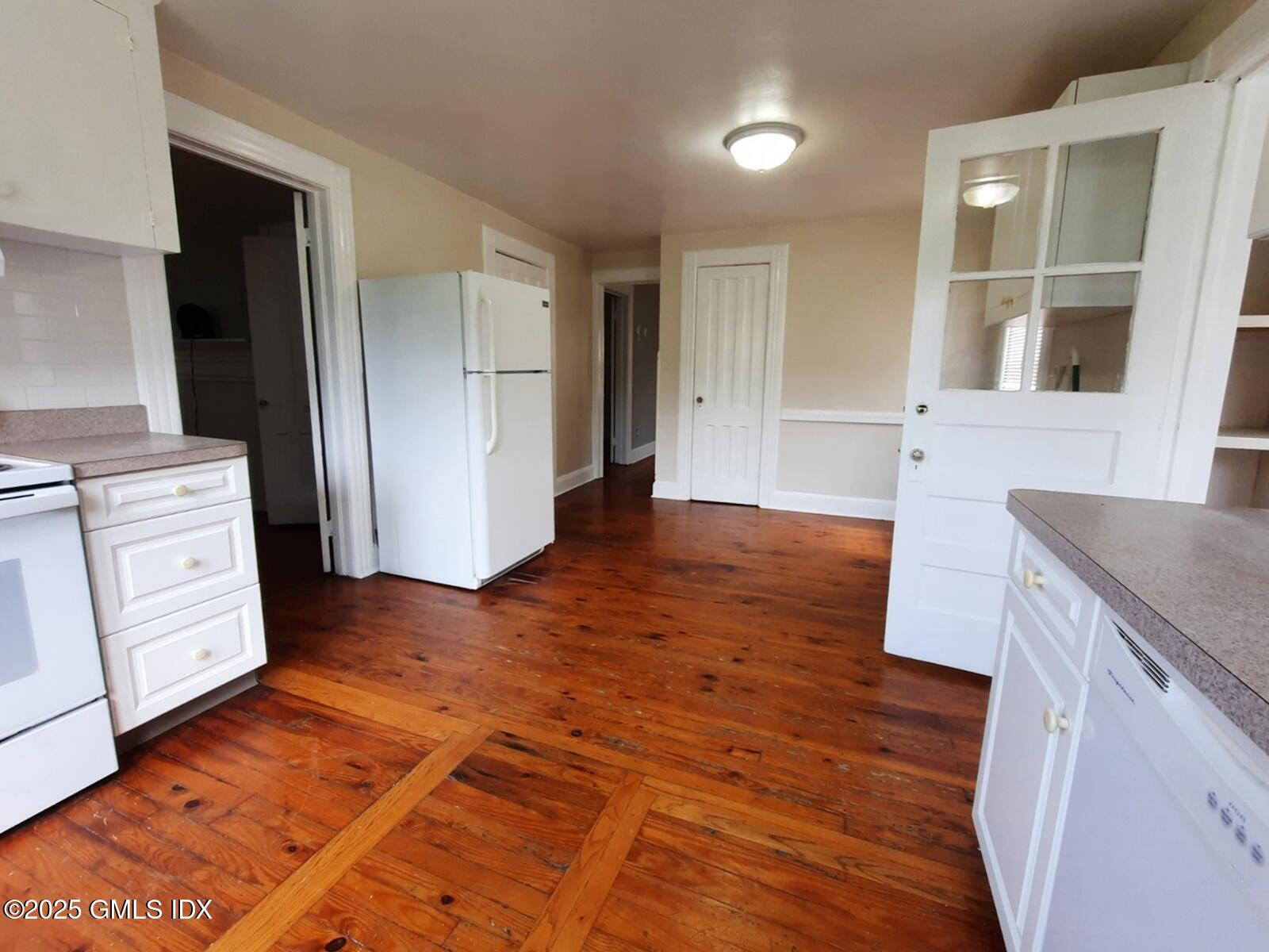 55 Valley Road Cos Cob, CT 06807 - Photo 5 of 21 an empty room with wooden floor and cabinet