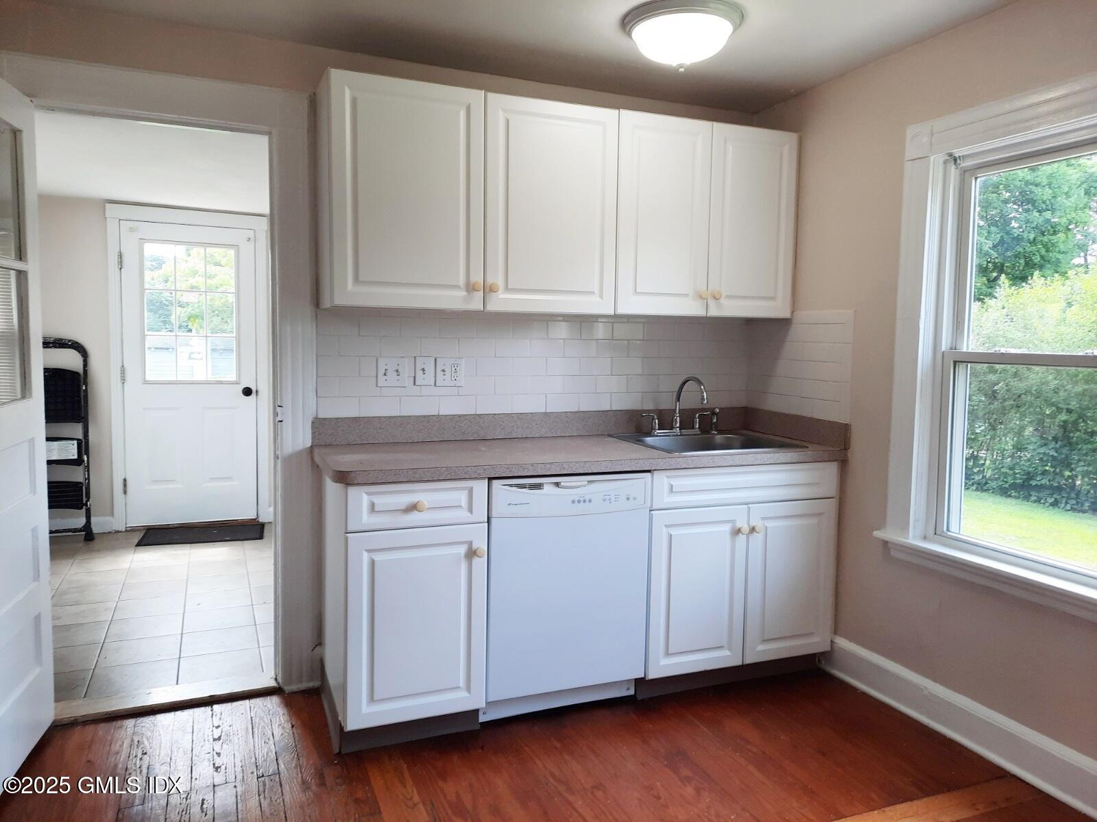 55 Valley Road Cos Cob, CT 06807 - Photo 8 of 21 a kitchen with stainless steel appliances granite countertop a sink and cabinets with wooden floor