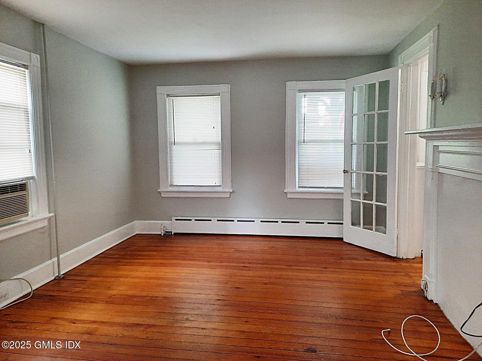 55 Valley Road Cos Cob, CT 06807 - Photo 10 of 21 an empty room with wooden floor and windows