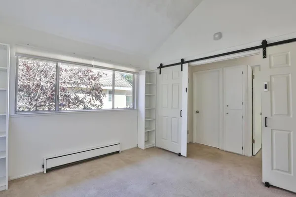 a view of an empty room with a window