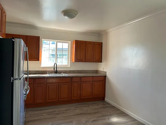 a kitchen with a refrigerator and a sink