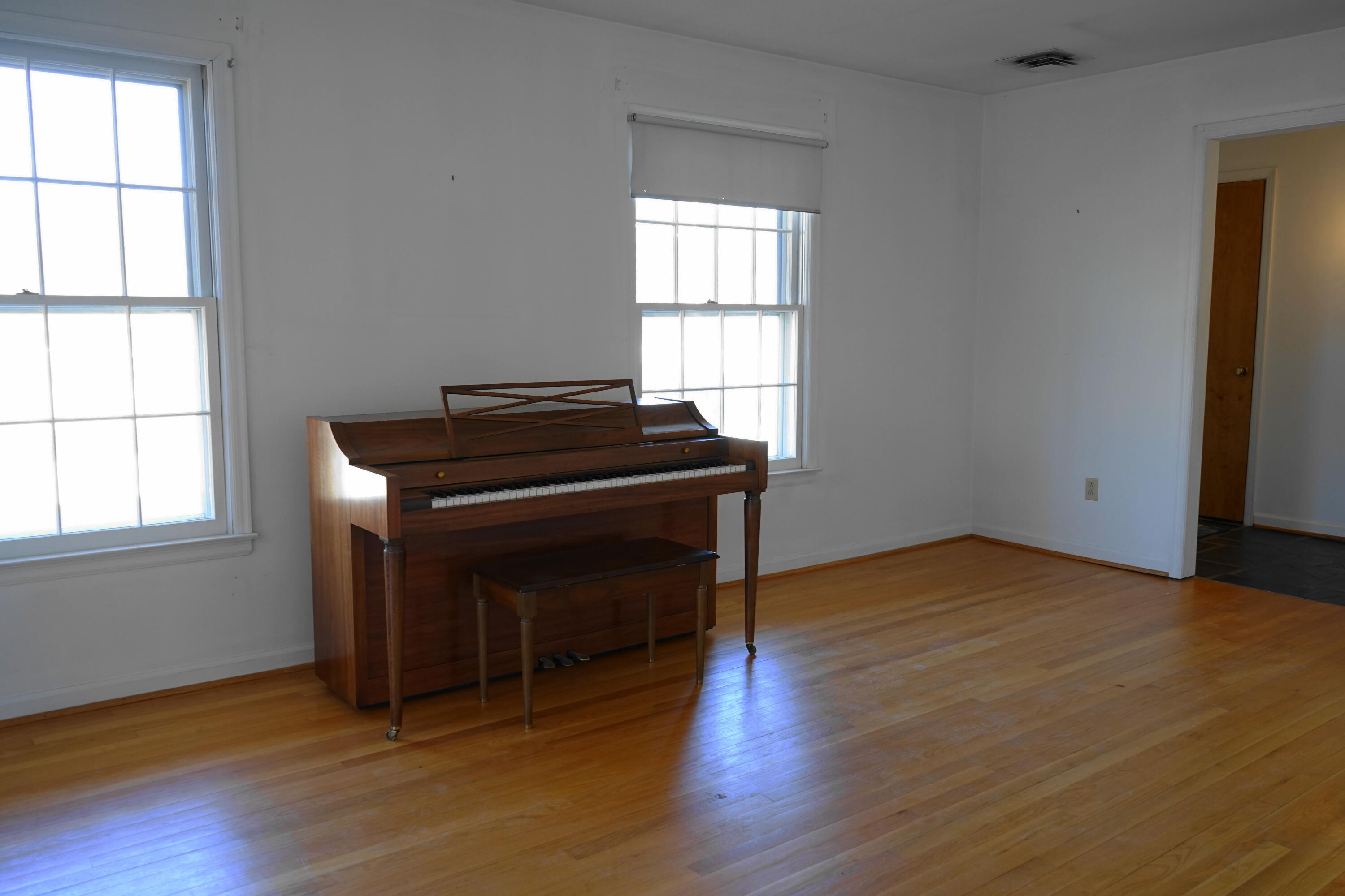 2231 Hardy Road Vinton, VA 24179 - Photo 12 of 38 an empty room with wooden floor cabinet and windows