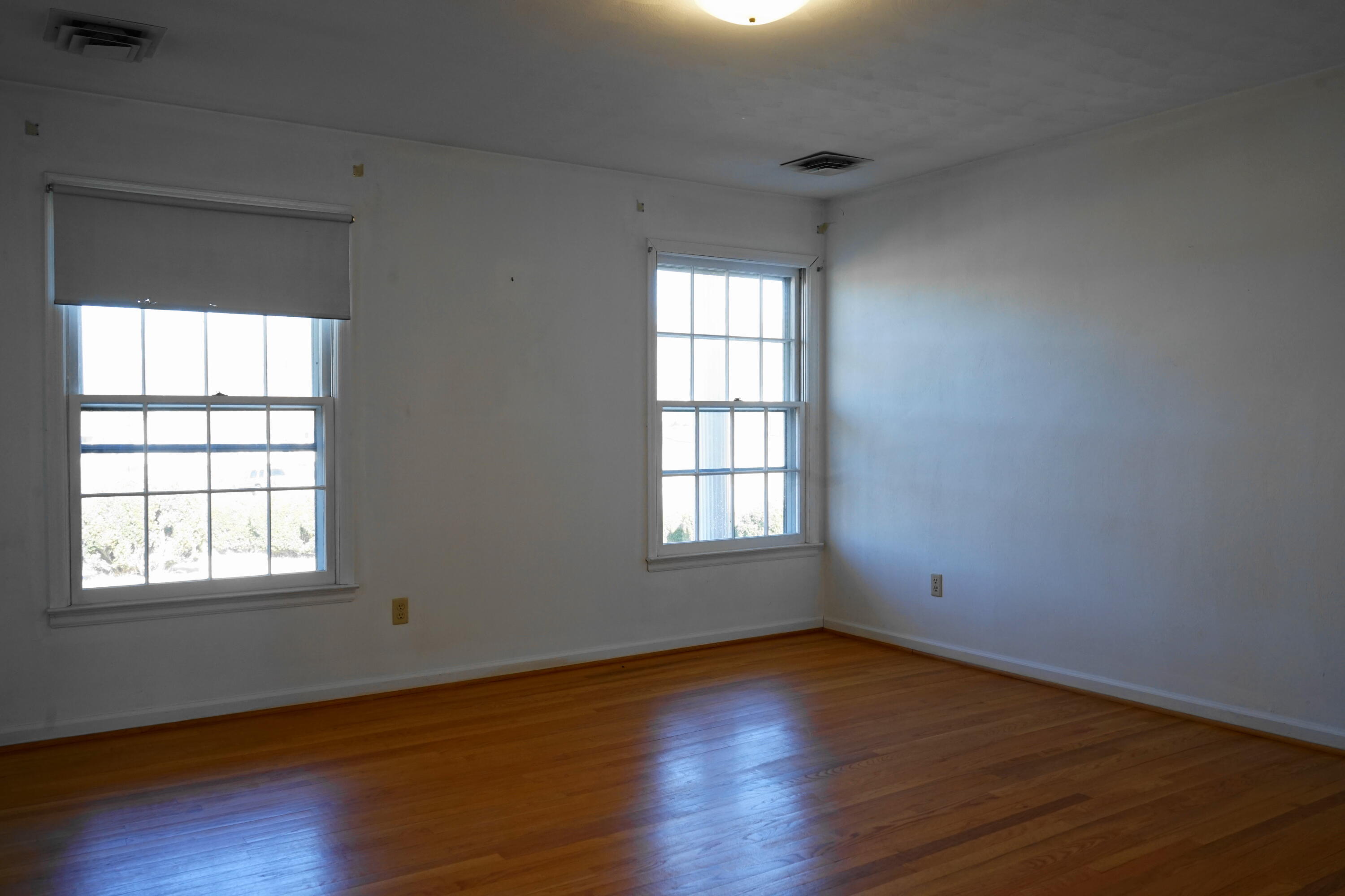 2231 Hardy Road Vinton, VA 24179 - Photo 21 of 38 an empty room with wooden floor and windows