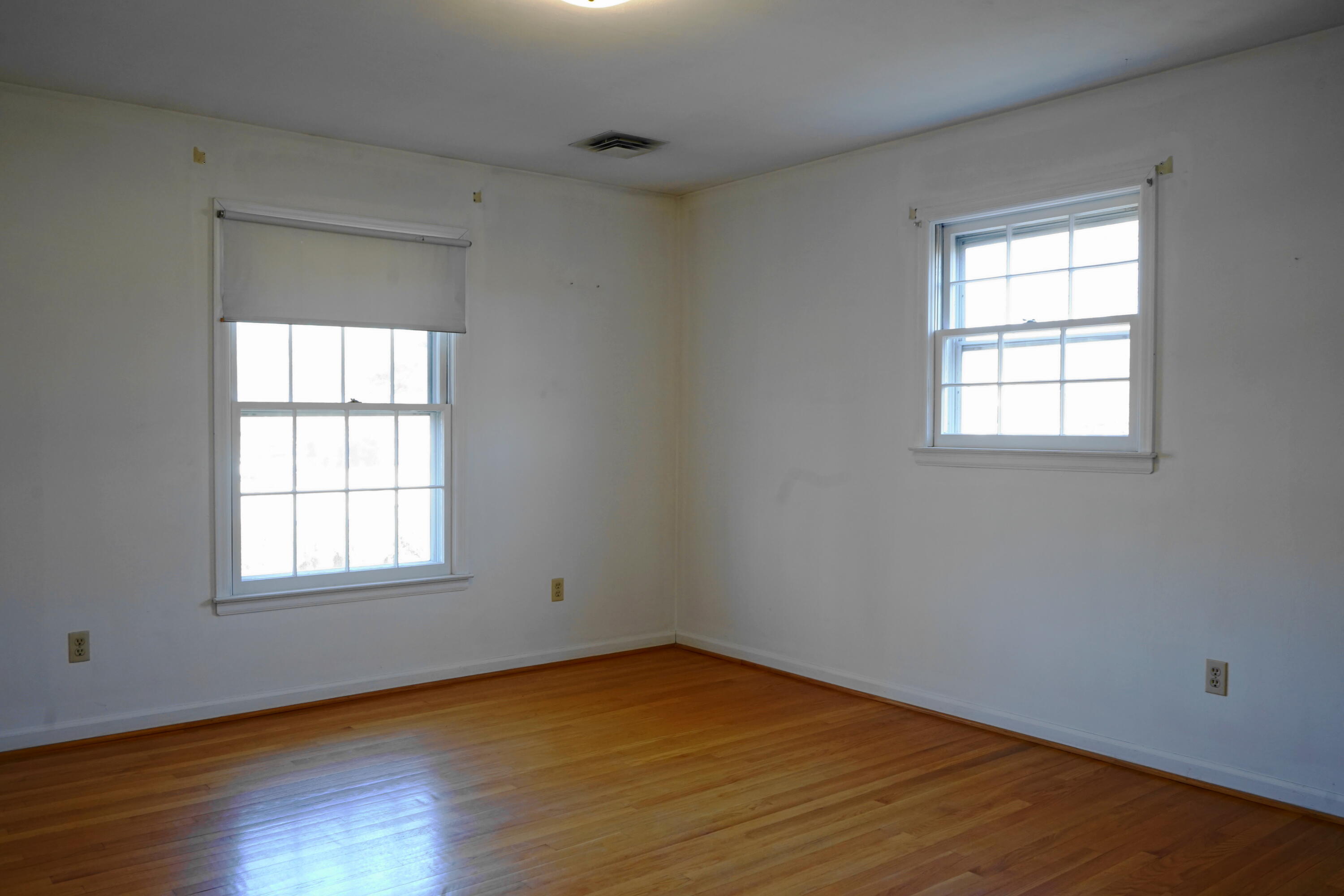 2231 Hardy Road Vinton, VA 24179 - Photo 24 of 38 an empty room with wooden floor and windows