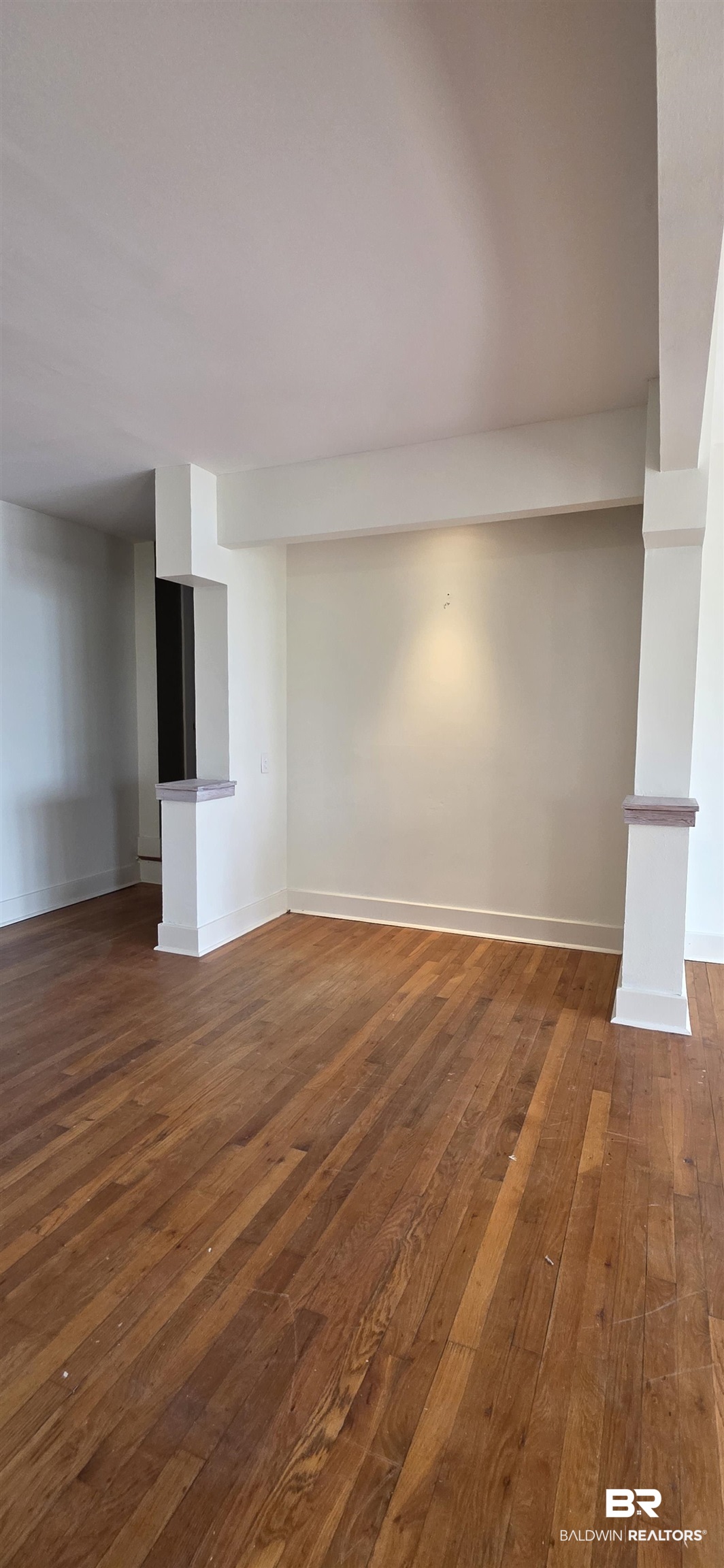 544 Windmill Ridge Road Gulf Shores, AL 36542 - Photo 24 of 50 Unfurnished living room with dark wood finished floors and baseboards