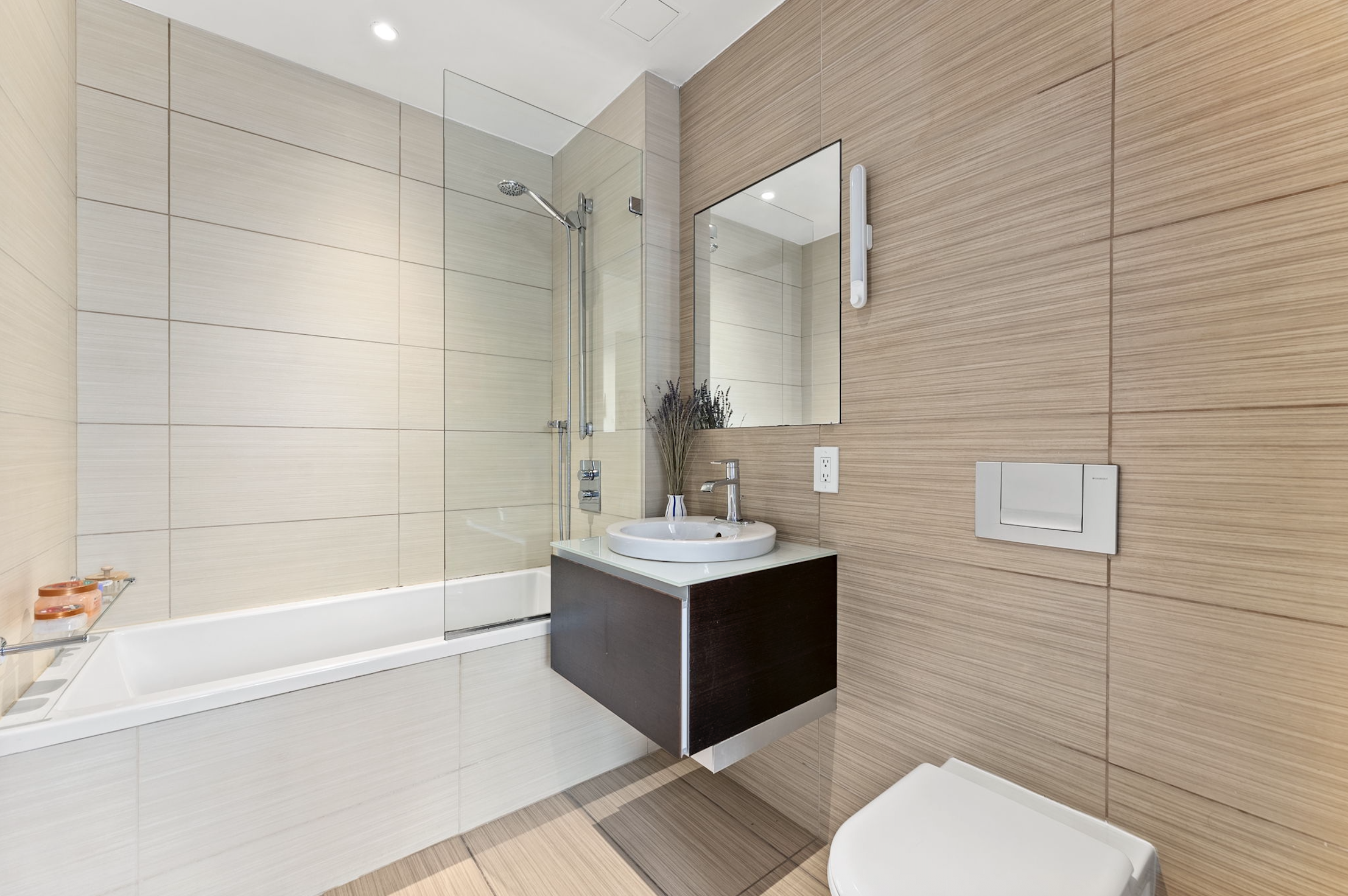 166 West 18th Street, Unit 2D Manhattan, NY 10011 - Photo 10 of 17 a bathroom with a sink toilet tub and shower