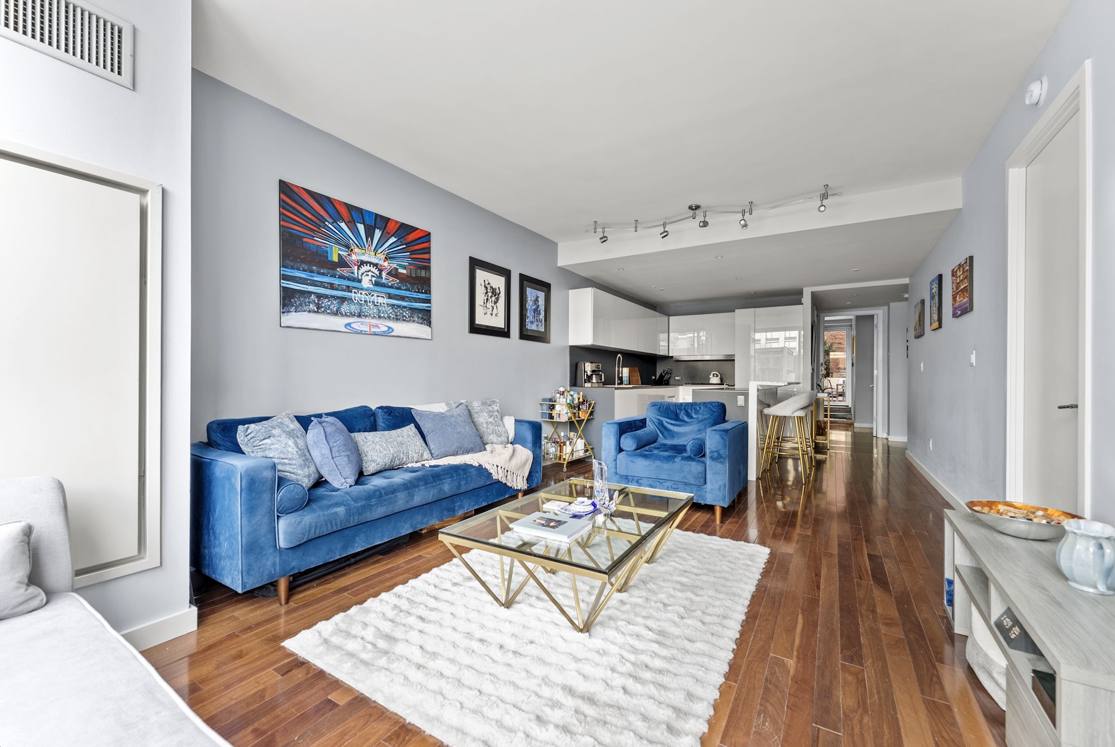 166 West 18th Street, Unit 2D Manhattan, NY 10011 - Photo 3 of 17 a living room with furniture and wooden floor