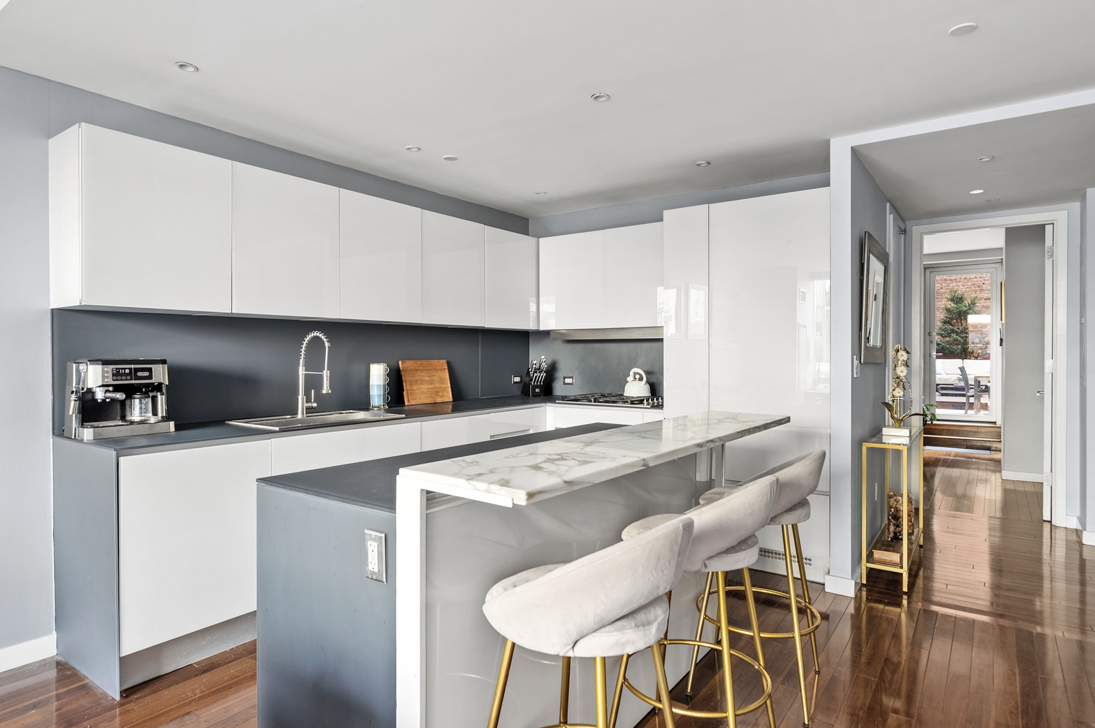 166 West 18th Street, Unit 2D Manhattan, NY 10011 - Photo 6 of 17 a kitchen with stainless steel appliances granite countertop a sink and a refrigerator
