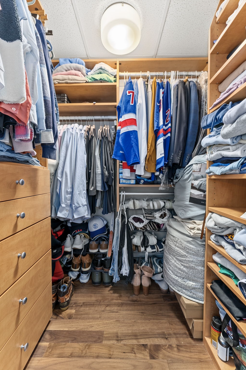 166 West 18th Street, Unit 2D Manhattan, NY 10011 - Photo 9 of 17 a view of walk in closet with clothes and shoes