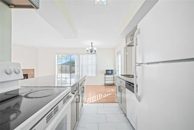 a kitchen with a sink and a stove top oven