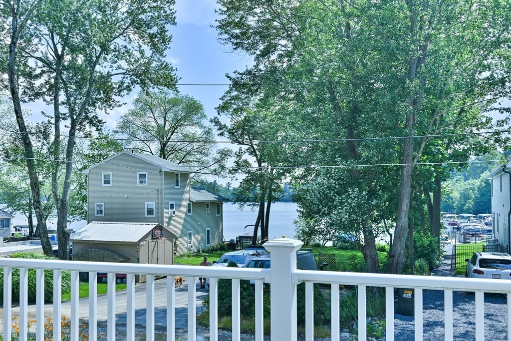20 Lakeview Road Webster, MA 01570 - Photo 13 of 42 a view of a white house with a large tree and wooden fence