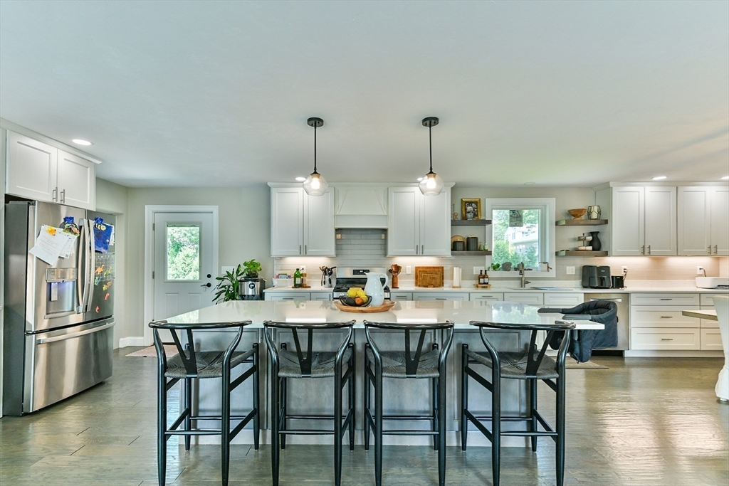 20 Lakeview Road Webster, MA 01570 - Photo 21 of 42 a kitchen with stainless steel appliances kitchen island granite countertop a dining table chairs and white cabinets