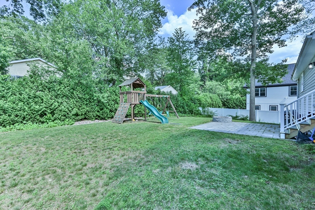 20 Lakeview Road Webster, MA 01570 - Photo 8 of 42 a view of a backyard with a slide trees and wooden fence