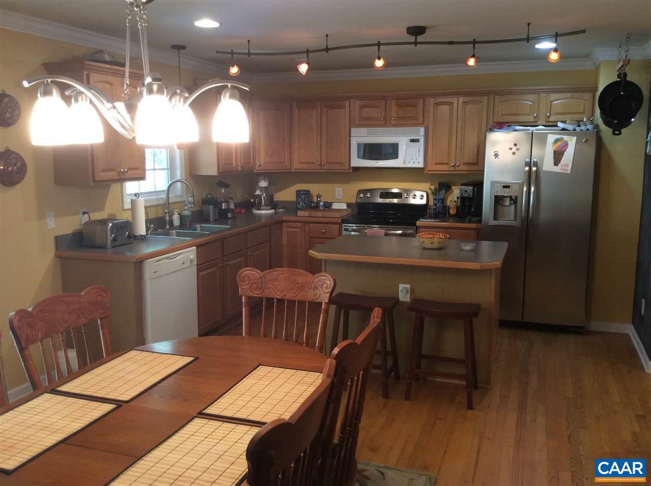 34 Xebec Road Palmyra, VA 22963 - Photo 5 of 28 a kitchen with stainless steel appliances granite countertop a table chairs sink refrigerator and microwave