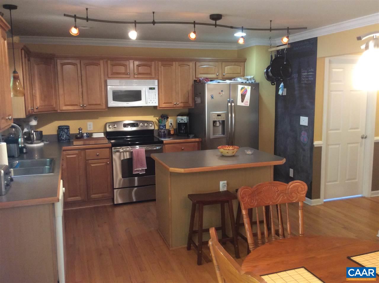 34 Xebec Road Palmyra, VA 22963 - Photo 8 of 28 a kitchen with stainless steel appliances granite countertop a refrigerator a stove top oven a sink dishwasher and white cabinets with wooden floor