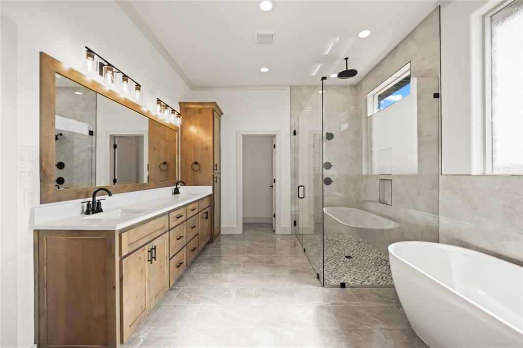 115 Red Bud Road Boyd, TX 76023 - Photo 23 of 38 Spacious bathroom featuring a double vanity with wood cabinetry, white countertops, and black fixtures