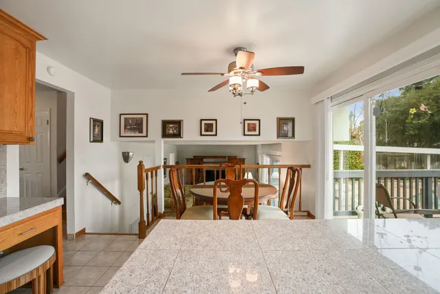 a view of a livingroom with furniture and a ceiling fan
