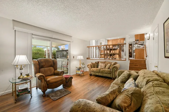 a living room with furniture and a lamp