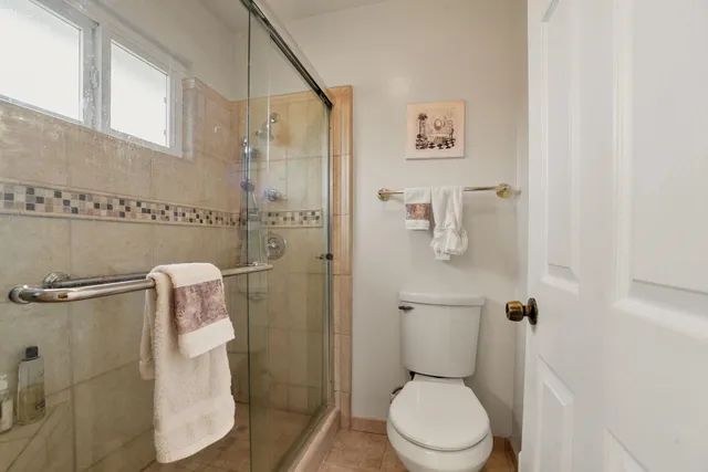 a white toilet sitting next to a bathroom sink