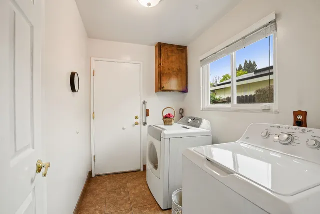 a bathroom with a granite countertop toilet and a mirror