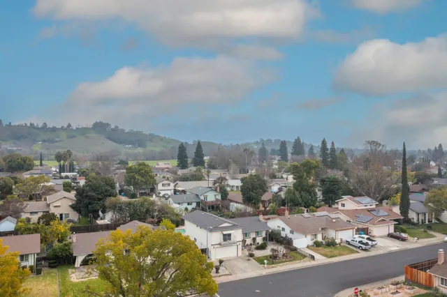 an aerial view of a house with garden space and street view