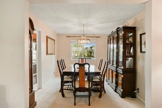a view of a dining room with furniture and window