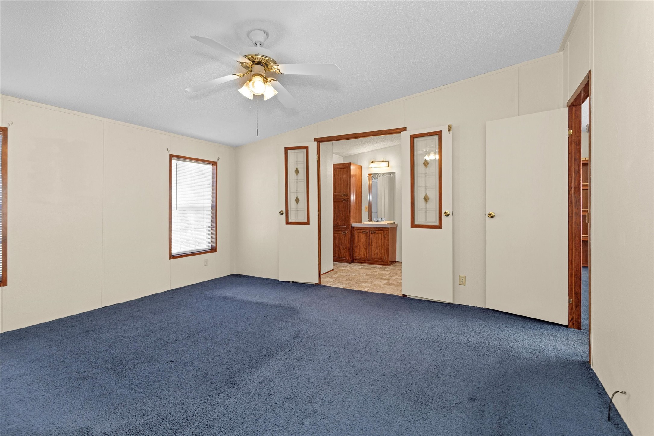 11261 Rose Road Conroe, TX 77303 - Photo 16 of 30 an empty room with chandelier fan and windows