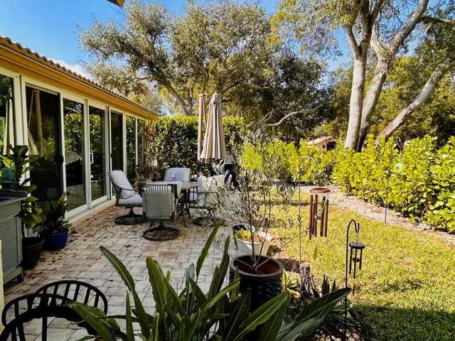 a view of a patio with table and chairs and potted plants