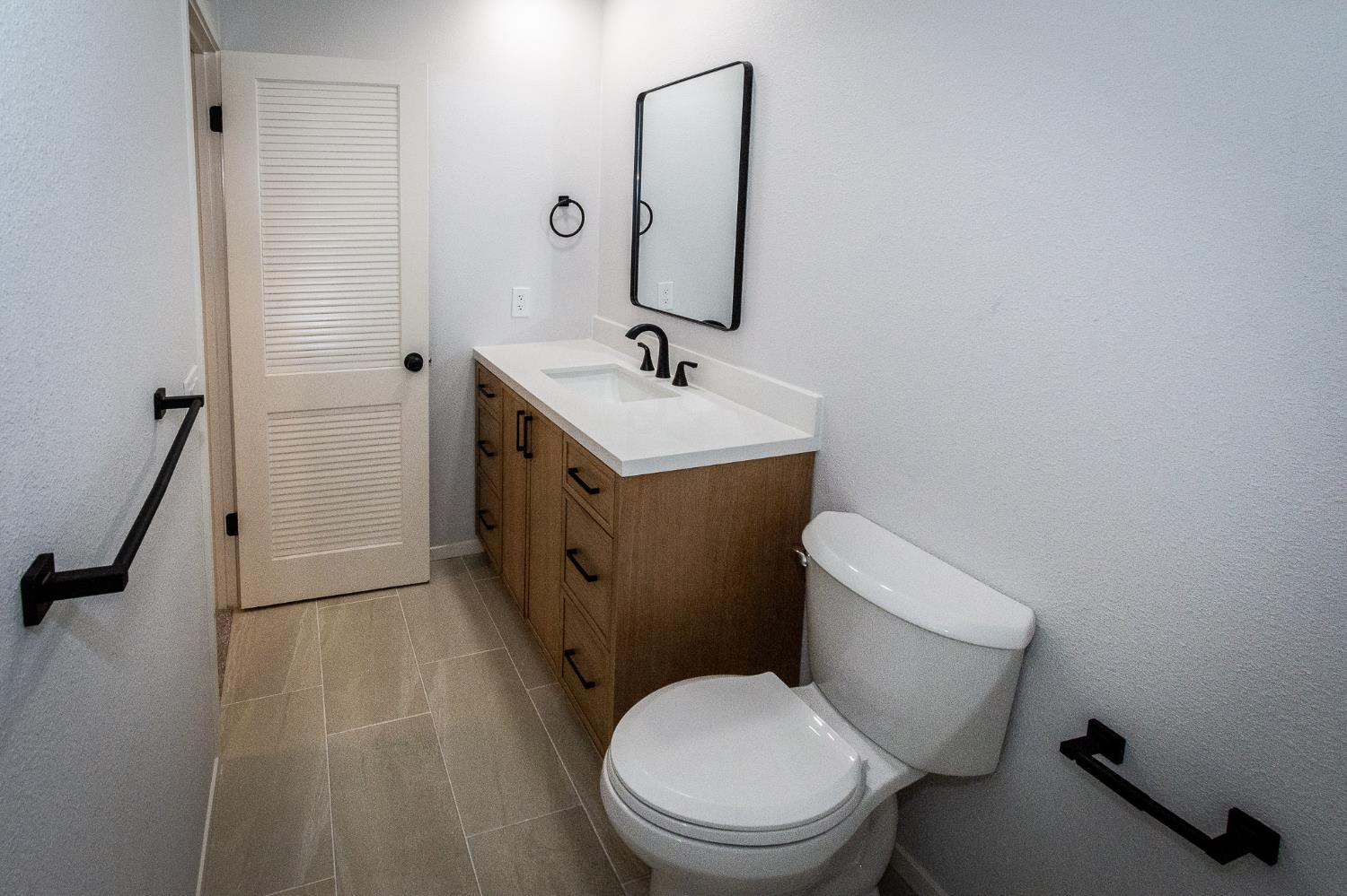 427 Wyndgate Road Sacramento, CA 95864 - Photo 16 of 35 a white toilet sitting next to a bathroom sink