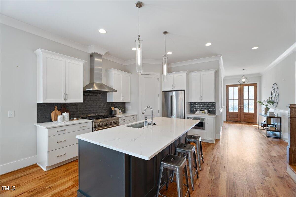 6152 Blanche Drive Raleigh, NC 27607 - Photo 11 of 47 a kitchen with a sink a stove a refrigerator and chairs