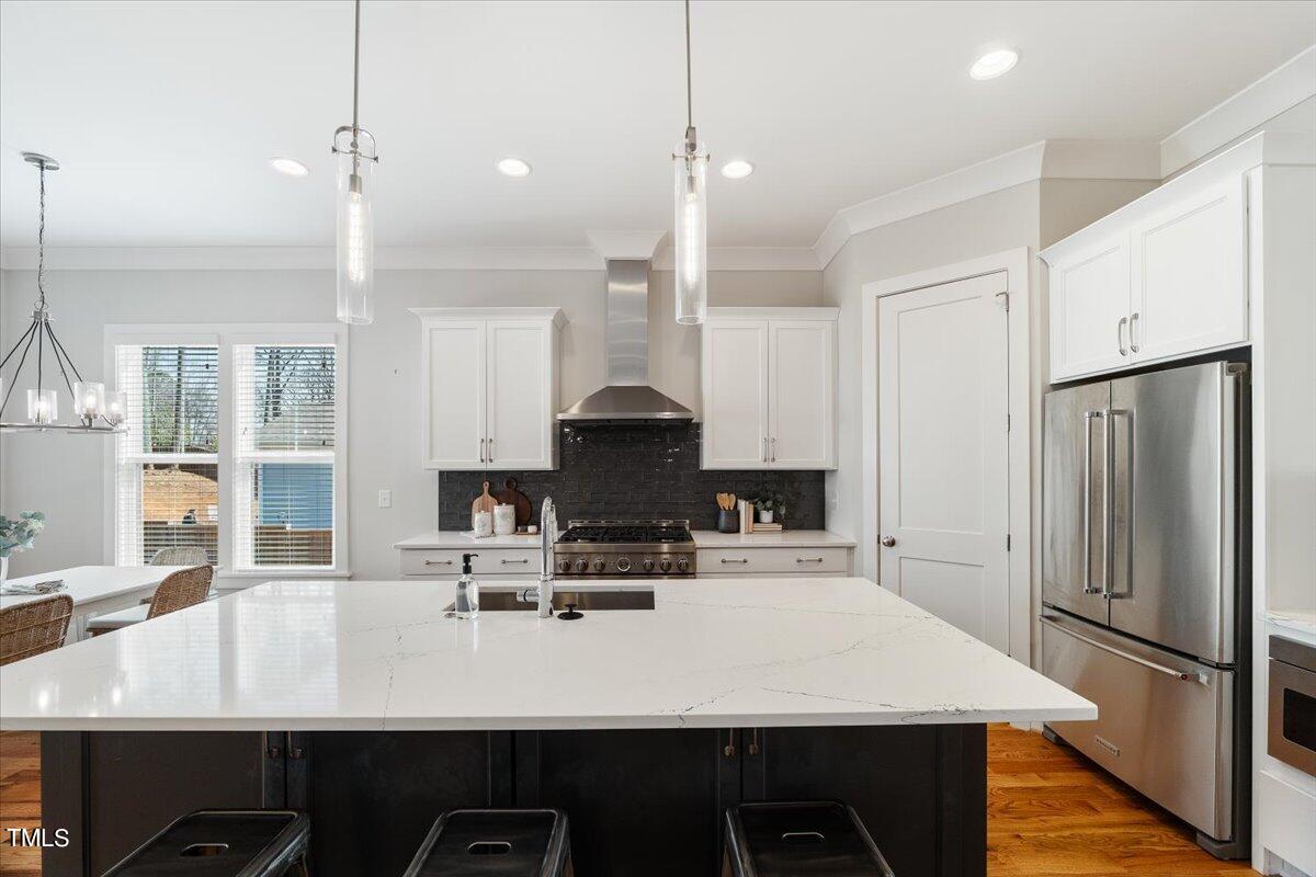 6152 Blanche Drive Raleigh, NC 27607 - Photo 13 of 47 a kitchen with kitchen island a sink stove and refrigerator