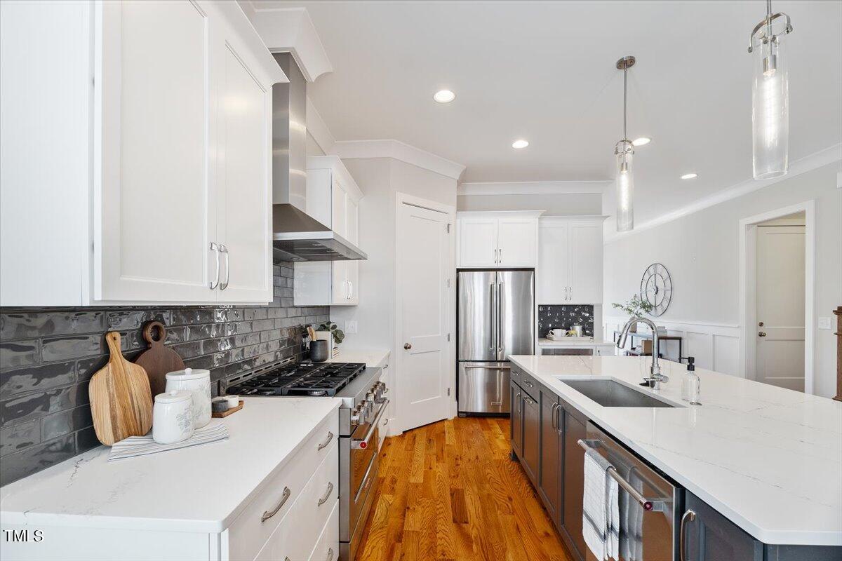 6152 Blanche Drive Raleigh, NC 27607 - Photo 16 of 47 a kitchen with stainless steel appliances a sink stove and refrigerator
