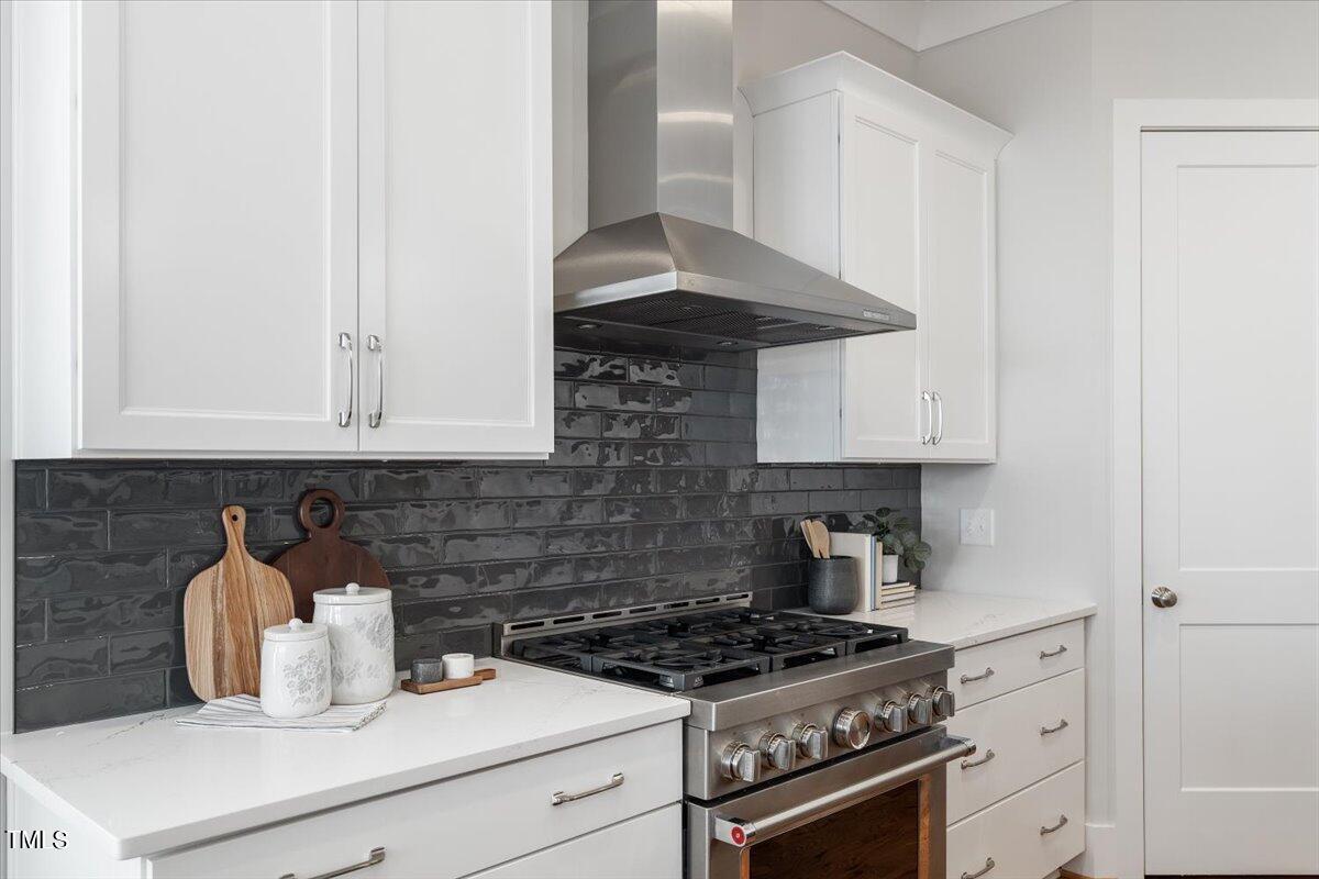 6152 Blanche Drive Raleigh, NC 27607 - Photo 17 of 47 a kitchen with stainless steel appliances a stove and cabinets