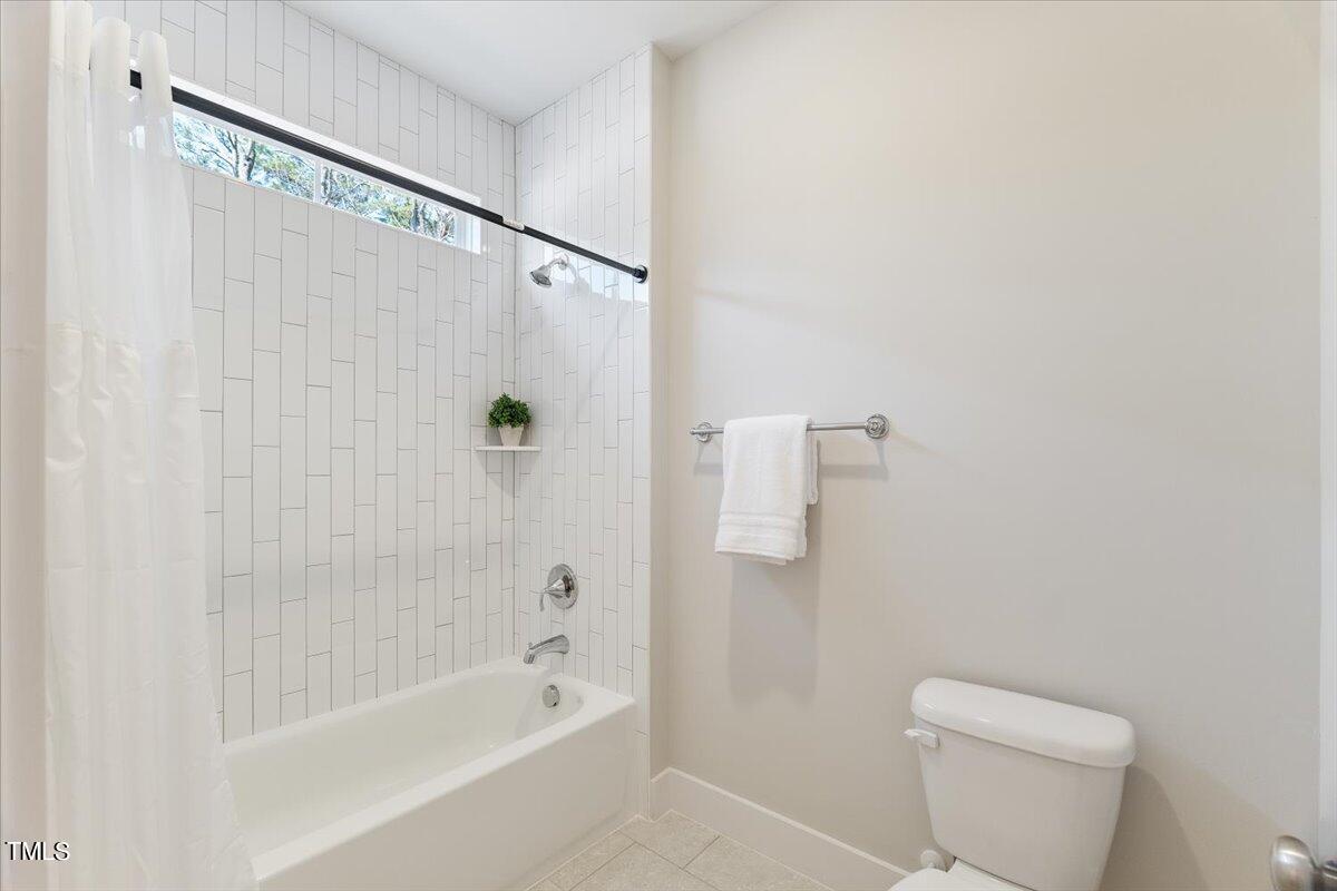 6152 Blanche Drive Raleigh, NC 27607 - Photo 40 of 47 a bathroom with a shower a toilet and a bathtub