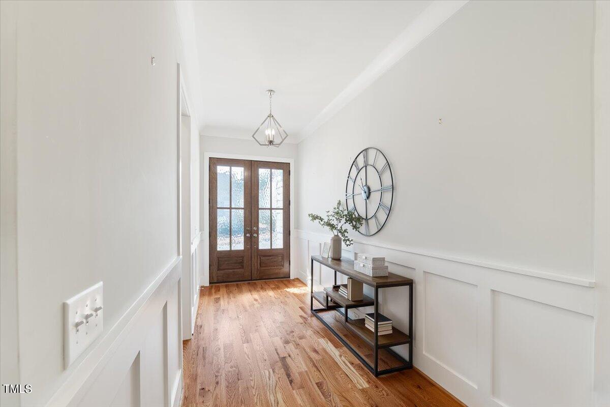 6152 Blanche Drive Raleigh, NC 27607 - Photo 4 of 47 a view of a room with wooden floor and white walls