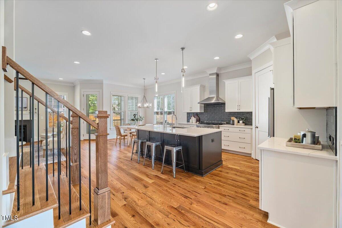 6152 Blanche Drive Raleigh, NC 27607 - Photo 5 of 47 a kitchen with a table chairs sink and cabinets