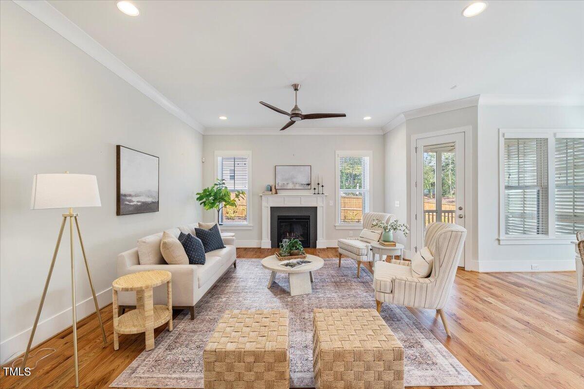 6152 Blanche Drive Raleigh, NC 27607 - Photo 6 of 47 a living room with furniture a fireplace and a table