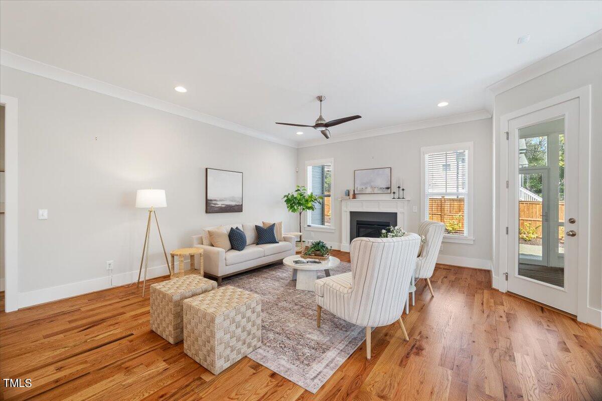 6152 Blanche Drive Raleigh, NC 27607 - Photo 7 of 47 a living room with furniture a fireplace and a wooden floor