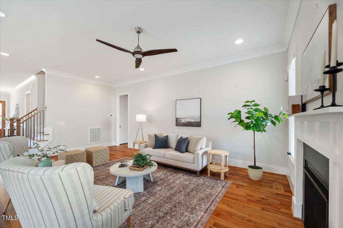 6152 Blanche Drive Raleigh, NC 27607 - Photo 8 of 47 a living room with furniture a fireplace and a potted plant