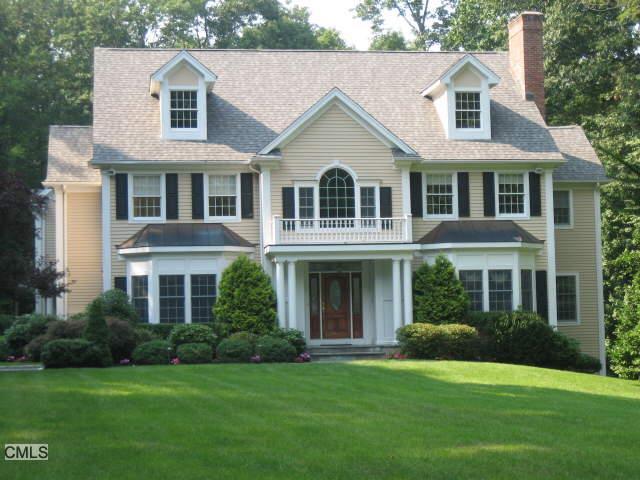 29 Powder Horn Hill Road Wilton, CT 06897 - Photo 1 of 1 a front view of a house with a garden