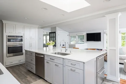 a kitchen with a stove a sink and a refrigerator