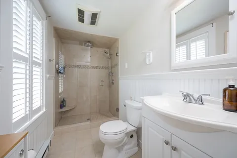 a bathroom with a sink toilet and shower